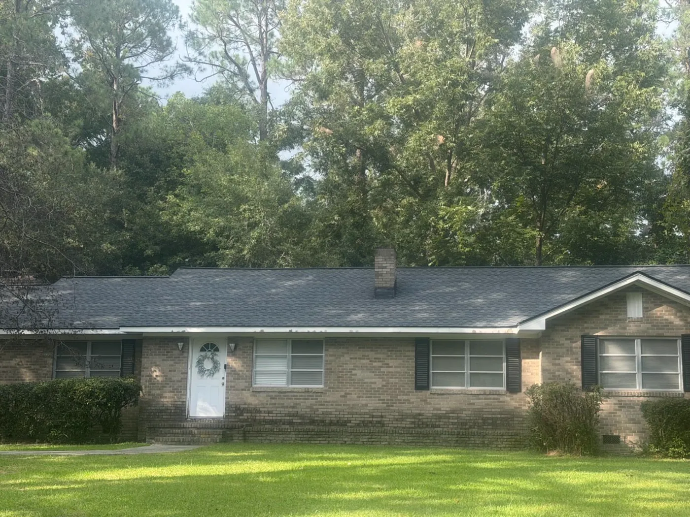 Brick ranch house in Middle Georgia with a new charcoal shingle roof by Residential Concerns