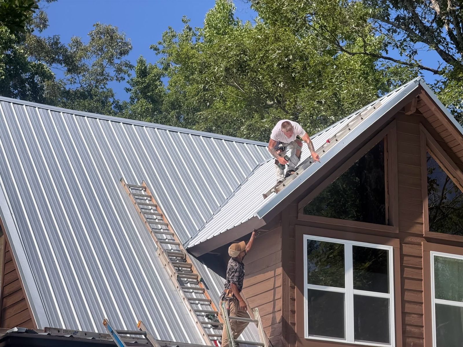 Residential Concerns crew installing a standing seam metal roof
