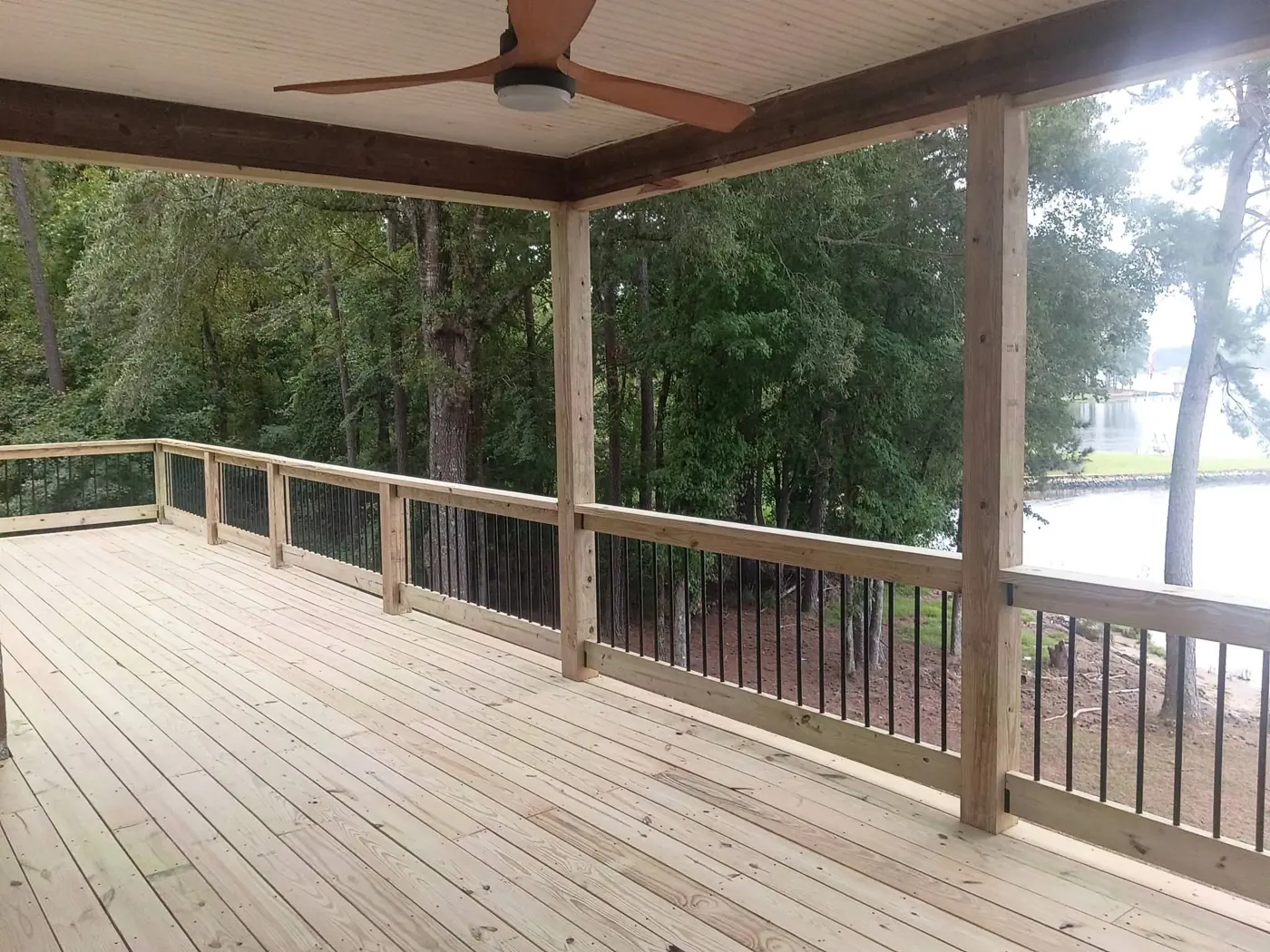 Finished elevated deck and covered porch on a Lake Sinclair home overlooking the water